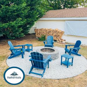 a patio with blue chairs and a fire pit at 3br-2ba I amazing outdoors I close to everything in Rehoboth Beach