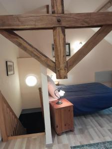 a bedroom with a bed and a lamp on a table at Badger Cottage in Salagnac