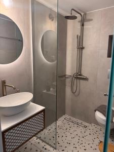 a bathroom with a sink and a glass shower at Kleanthi Studios in Chania +70 photos