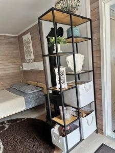 a shelf in a room with a bed at Evija in Ventspils