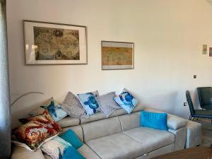 a living room with a couch with pillows on it at Sea View Holiday for Family and Friends Aheloy, near Sunny Beach-Почивка с изглед към морето за семейство и приятели Ахелой, близо до Слънчев бряг in Aheloy