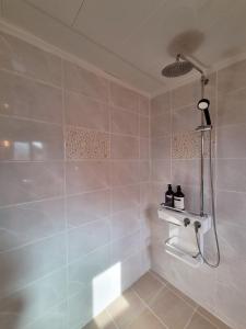 a bathroom with a shower and a sink at Haenarr Hanok Stay in Mandarin Orchard, 100m from Sea in Seogwipo