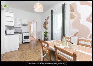 a kitchen and dining room with a table and chairs at RASL Residens,apartmán Art deco in Jihlava +10 photos