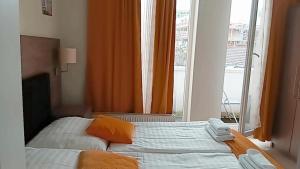a bedroom with two beds in front of a window at Hotel Cara Vita Cologne in Cologne +67 photos