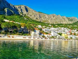 a view of a beach with a mountain in the background at Apartments Ivka in Omiš