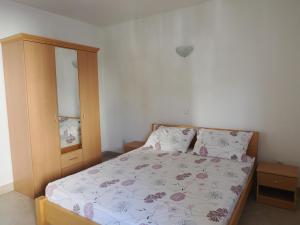 a small bedroom with a bed and a dresser at Villa Njavro in Neum