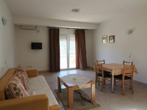 a living room with a couch and a table at Villa Njavro in Neum
