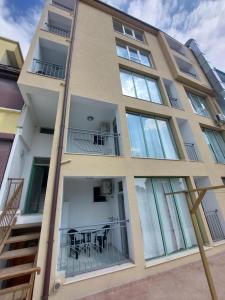 an apartment building with glass windows and a table at Guest house WEST in Sunny Beach +65 photos