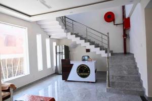 a staircase in a living room with a stair case at Home O Maa Radhika inn in Ayodhya