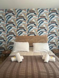 a bedroom with a bed with a blue and white wallpaper at Maison LARLY Arles Swimming pool in Arles +33 photos