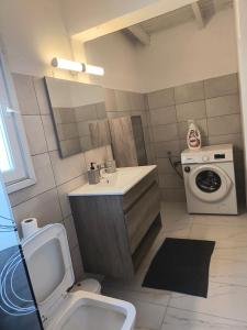 a bathroom with a sink and a washing machine at Summer house, Μονοκατοικία 120 in Eretria +24 photos