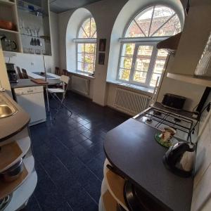 a kitchen with a stove and a counter top at Large 3-room apartment in a historic house in Tallinn