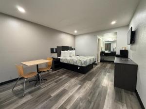 a bedroom with a bed and a desk and a table at Motel 6-Tacoma, WA - South in Tacoma +37 photos