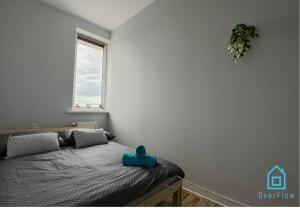 a bedroom with a bed with a blue toy on it at Morska Aqua Therapy Room nr 3 in Gdynia