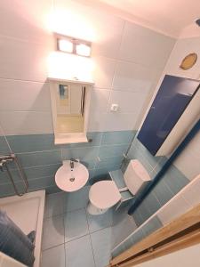 a bathroom with two toilets and a sink at B42 Cozy in Budapest