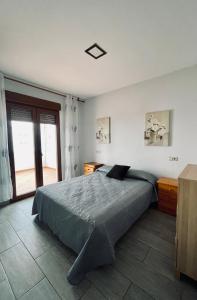 a bedroom with a large bed with a window at Edificio Guadalupe in Alcossebre +7 photos