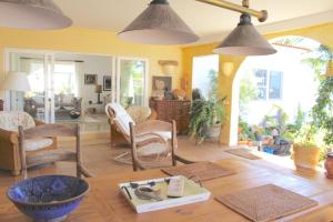 a living room with a table and some chairs and lights at villa jardin al mar in Playa Jandia