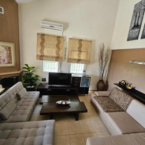 a living room with two couches and a coffee table at paralia ofriniou beautiful house in Karianí