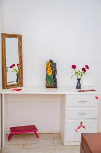 a white desk with a mirror and flowers on it at Casa c Wifi, churrasq, pisc, redario, Pet friendly in Benfica +41 photos