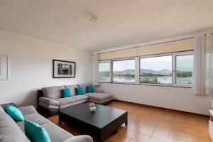 a living room with a couch and a table at Casa Sa Minda by Wonderful italy in Olbia