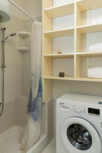 a bathroom with a washing machine and a shower at Casa Sa Minda by Wonderful italy in Olbia