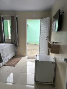 a bedroom with a bed and a view of the ocean at Pousada Recanto do Una in Morros