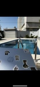 a table with two faucets next to a swimming pool at Вилла,Дача на берегу моря in Baku
