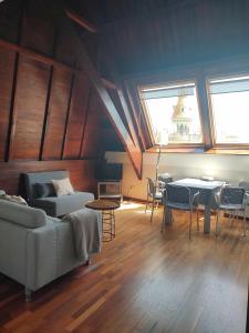 a living room with a couch and tables and windows at Passeig De Gràcia Luxury in Barcelona