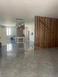 an empty room with a wooden wall and a living room at Вилла,Дача на берегу моря in Baku