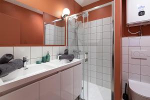 une salle de bain avec deux lavabos et une douche dans l'établissement Let's- 2 and 1 - Sweet Voltaire, à Lyon