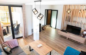 a living room with a couch and a flat screen tv at House For Rest VIN in Kolašin