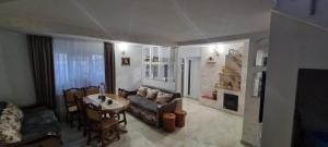 a living room with a couch and a table at Casa Sara in Eforie Nord