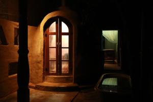 a door in a dark room with a window at Ella Village House in Ella