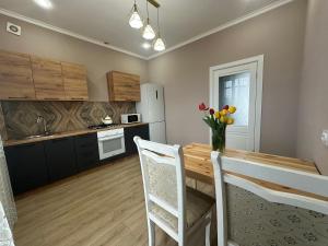 a kitchen and dining room with a table and chairs at Park home Uralsk in Uralsk +7 photos