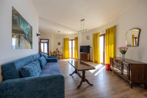 a living room with a blue couch and a table at Adrian in Rafailovici