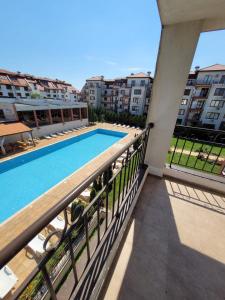 a balcony with a swimming pool and some buildings at Famagusta Antoniya in Aheloy +1 photo