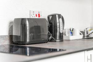 a kitchen counter with two toasters and a toaster at Private Studio in Dudley,Kitchen&Bathroom,Sleeps 1 in Dudley