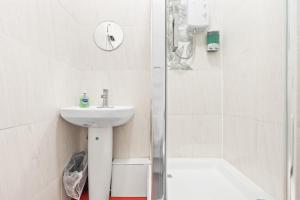 a white bathroom with a sink and a shower at Private Studio in Dudley,Kitchen&Bathroom,Sleeps 1 in Dudley