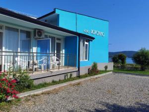 a blue building with a sign on the side of it at хотел Ропотамо in Primorsko