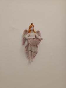 a small angel figurine on a white background at da Mescia Maria in Morciano di Leuca