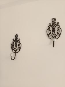 a pair of wall hooks on a white wall at da Mescia Maria in Morciano di Leuca
