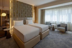 Tempat tidur dalam kamar di Nobel Design Hotel