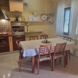 a kitchen with a dining room table and chairs at Superior apartment Nina in Povljana +10 photos