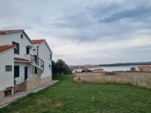 a house with a view of the water at Superior apartment Nina in Povljana