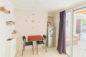a kitchen with a table and chairs and a refrigerator at My Summerhouse with jacuzzi in Kremasti