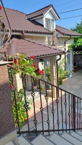 a house with a balcony with a plant at Casa Sara in Eforie Nord