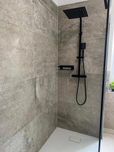 een douche met een douchekop in een badkamer bij Pension Leipzig Ost in Borsdorf