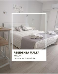 a bedroom with a bed with towels on it at Residenza Malta in Pizzo