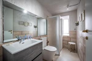 a bathroom with a sink and a toilet and a mirror at La Loggia del Porcellino in Florence +84 photos
