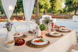 Una mesa con platos de comida encima en Trulli in Contrada - Monopoli, en Monopoli 49 fotos más
